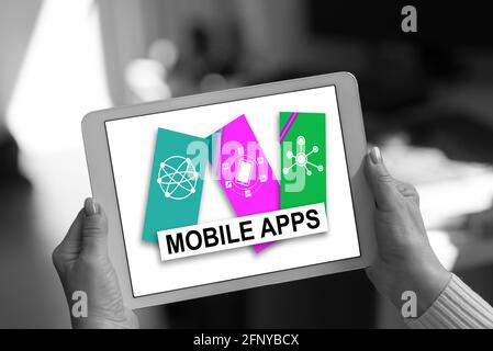 Mobile apps concept shown on a tablet held by a woman Stock Photo