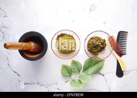 The wooden bowl with rehydrated henna on table Stock Photo