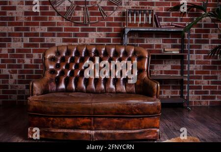 Old leather sofa. Brown furniture. Retro bed with a soft back Stock Photo