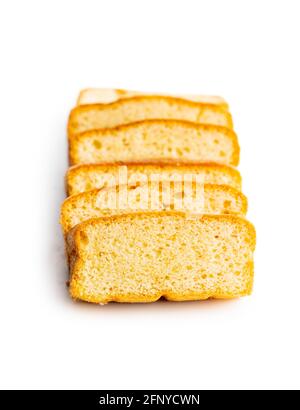 Sliced sponge dessert. Sweet sponge cake isolated on white background. Stock Photo