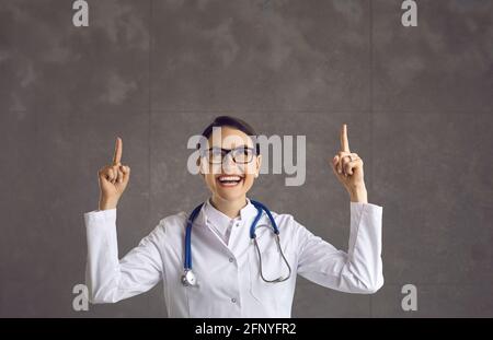 Young female doctor idea making good idea gesture with two hands studio headshot Stock Photo