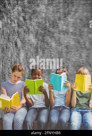 Composition of group of schoolchildren reading holding books on grey background Stock Photo