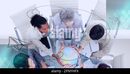 Composition of network of connections over globe held by business people Stock Photo