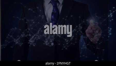 Network of connections against mid section of businessman touching invisible screen Stock Photo