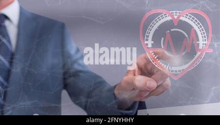 Heart rate and network of connections against mid section of businessman touching invisible screen Stock Photo
