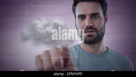 Cloud inside a cube against caucasian man touching invisible screen Stock Photo