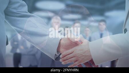 Digital composite image of cloud icon against mid section of two businessmen shaking hands at office Stock Photo