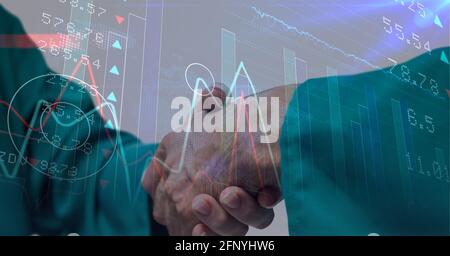 Statistical and stock market data processing against mid section of surgeons shaking hands Stock Photo