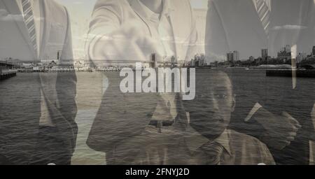 Composition of businessman pointing at camera over cityscape Stock Photo
