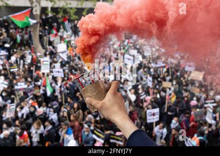 Smoke grenade held over crowd, 'Free Palestine' solidarity protest, London, 15 May 2021 Stock Photo