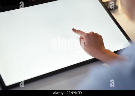 hand on led light tablet at night office Stock Photo
