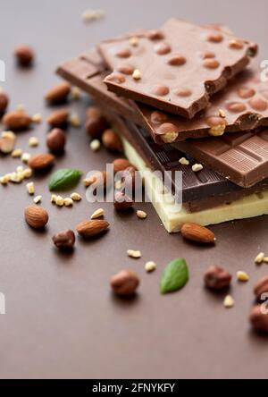 close up of different chocolate bars and nuts Stock Photo