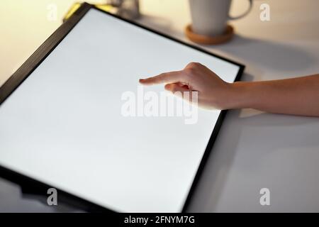 hand on led light tablet at night office Stock Photo