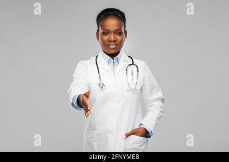 african american female doctor making handshake Stock Photo