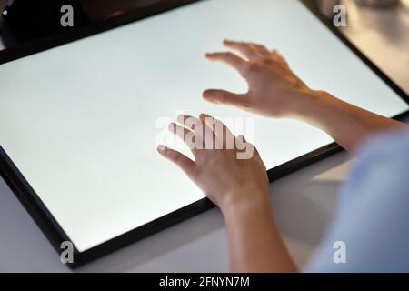 hands on led light tablet at night office Stock Photo