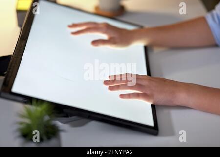hands on led light tablet at night office Stock Photo