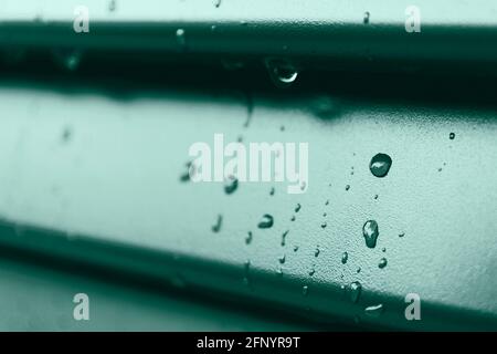 Macro of raindrops on the green shutter, detail Stock Photo