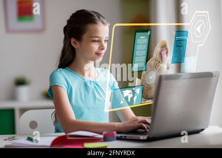 girl with laptop learning nature online at home Stock Photo