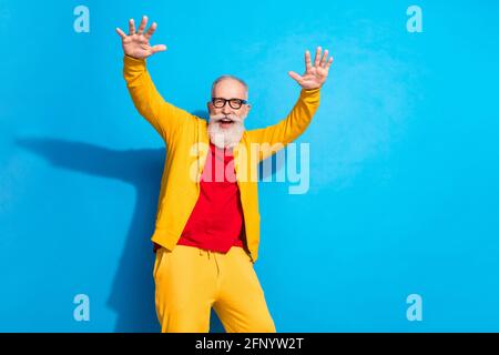 Photo of funky crazy happy positive excited grandfather dancing wear yellow tracksuit isolated on blue color background Stock Photo