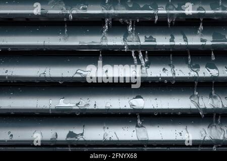Raindrops and drip water on the shutter, detail Stock Photo