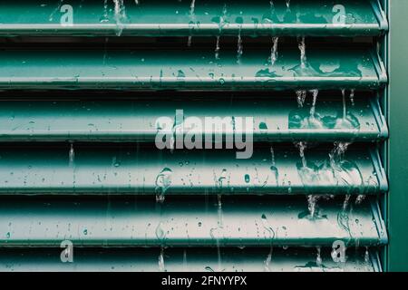 Raindrops and drip water on the shutter, detail Stock Photo
