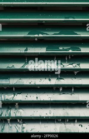 Raindrops and drip water on the shutter, detail Stock Photo
