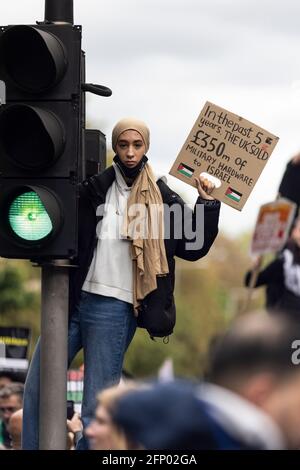 Protester with placard standing on traffic lights, 'Free Palestine' solidarity protest, London, 15 May 2021 Stock Photo