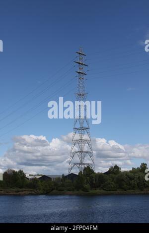 Erskine, Dumbartonshire. Scotland. UK Large electricity pylons by the River Clyde. Portrait format Stock Photo