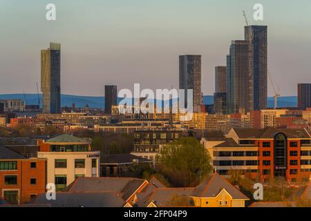 View of Manchester skyline and rooftops at sunset from Salford Quays, Manchester, England, United Kingdom, Europe Stock Photo