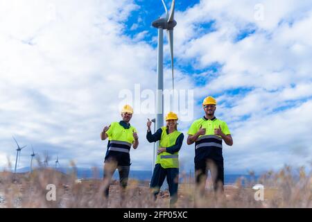 Happy engineers for their job. Skilled workers gives me a thumbs-up, smiles and  looking the camera. Job and renewable energy concept. Stock Photo