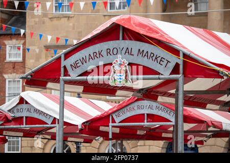 The stalls of Newark Royal Market in the market square. Newark has proudly held a market in the town market place since the 12th century and was the first town in England to hold a market on a Wednesday.  The market place itself is one of the most attractive market places in the UK containing many historic and heritage rich buildings. Stock Photo