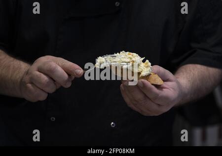 Closeup shot of a male cook's hands holding a Basque appetizer Stock Photo