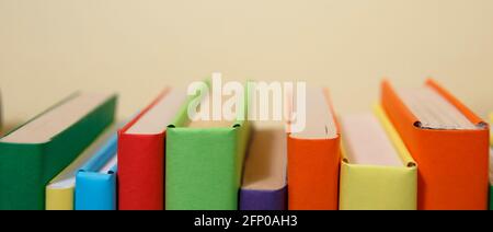 Composition with vintage old hardback books, colored background. Books stacking. Back to school. Copy Space. Education background. Stock Photo