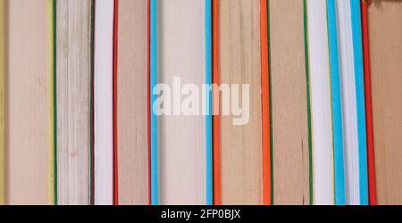 Composition with vintage old hardback books, colored background. Books stacking. Back to school. Copy Space. Education background. Stock Photo