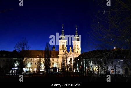 Scenic nocturne view of Mariahilferkirche, a 13th century Baroque style church in Graz the capital of Styria, Austria. Stock Photo