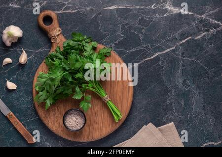 cutting board, parsley on a marble table, top view Stock Photo