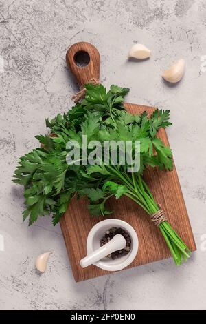 cutting board, parsley on a concrete table, top view Stock Photo