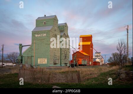 Nanton, Alberta - May 7, 2021: Elevator row in Nanton Alberta. These grain elevators have been preserved as heritage buildings. Stock Photo