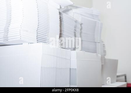 Large number of folded cardboard boxes .Cardboard boxes stored. Pile of collapsed cardboard boxes. Stock Photo