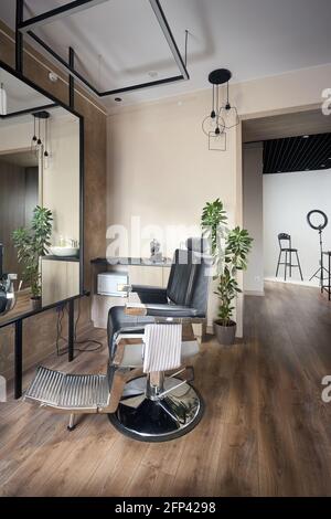 Barber shop or barbershop vintage interior design hair man salon empty with chair and photo studio. Vertical shot. Stock Photo