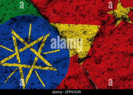 Concept of a Conflict in the Ethiopian Region of Tigray with painted flags on a rough wall with a crack Stock Photo