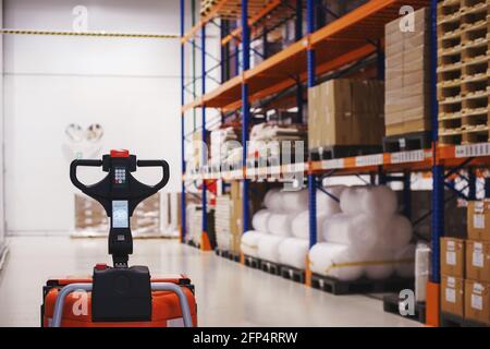 Electric forklift in modern warehouse with targeted storage system. Stock Photo
