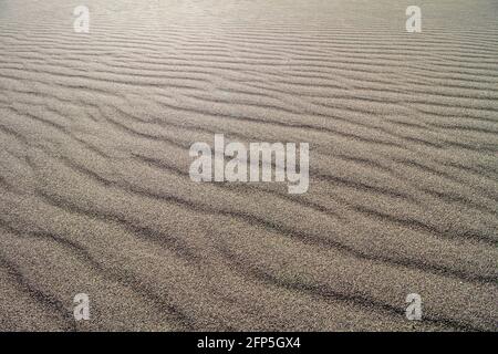 wind blowing sand into ripples Stock Photo