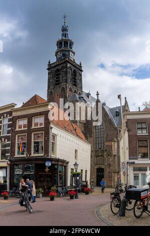 Gouda, Netherlands - 15 May, 2021: view of the historic city center of Gouda with people riding bicycles Stock Photo
