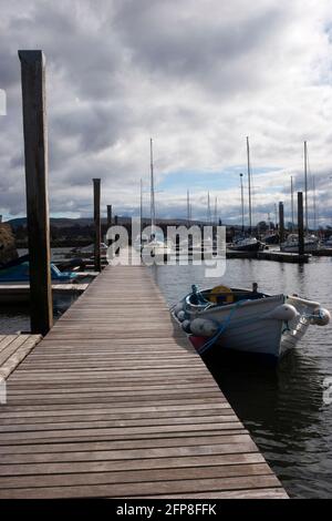 Rowing boat tied up at a Scottish loch jetty Stock Photo - Alamy
