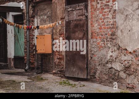 colorful gloves drying on a line in a small yard Stock Photo