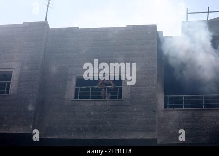 Smoke rises following Israeli airstrikes on a building. Gaza City. Stock Photo