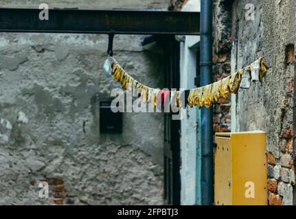 colorful gloves drying on a line in a small yard Stock Photo