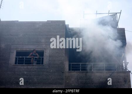 Smoke rises following Israeli airstrikes on a building. Gaza City. Stock Photo