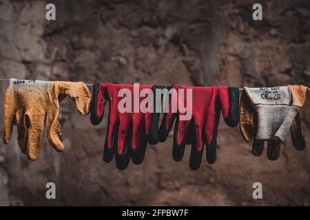 colorful gloves drying on a line Stock Photo